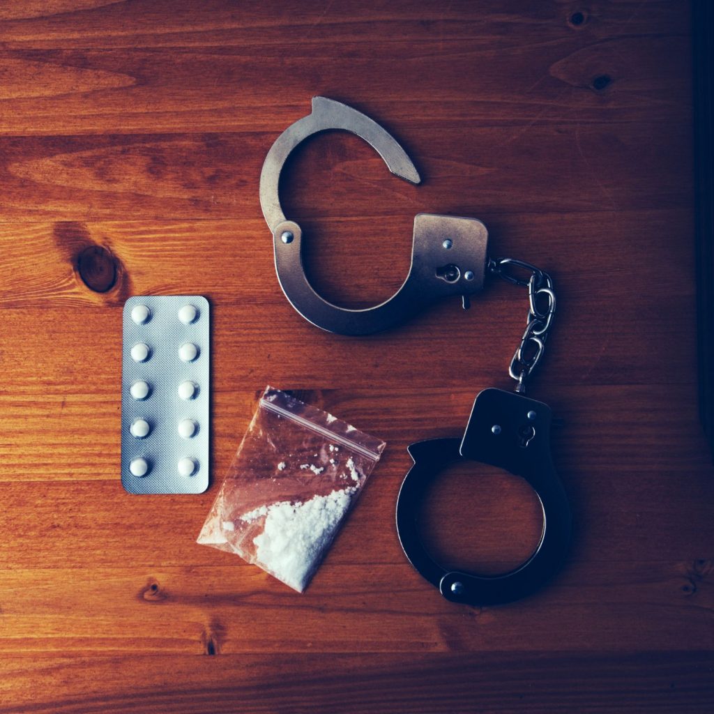 collected drugs and cuffs for drug charges