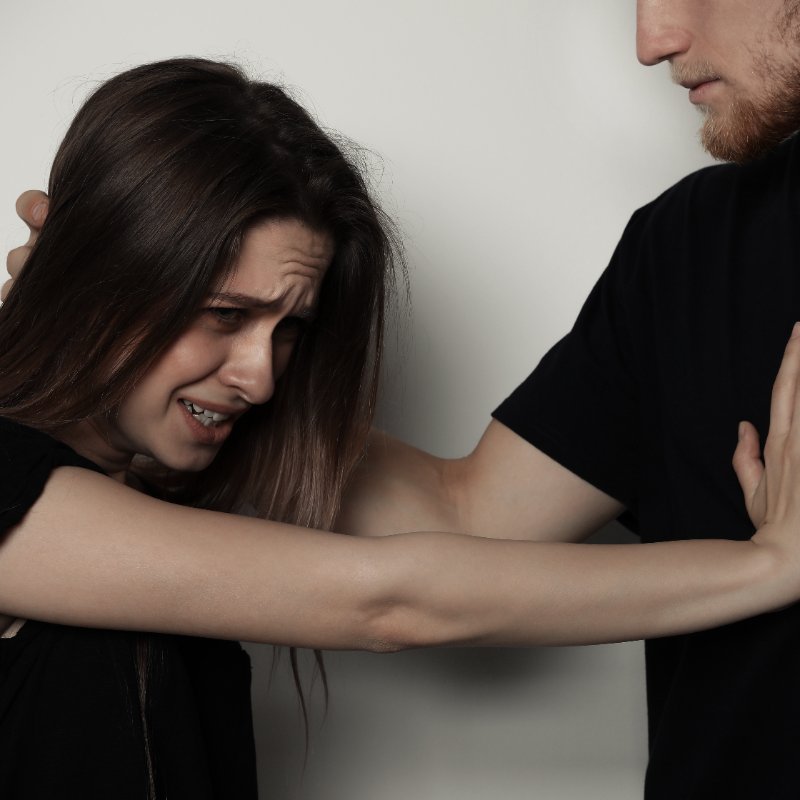 scared woman being attacked by a man