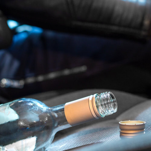 bottle of alcohol on a car seat